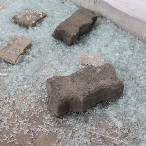image of a concrete bricks laying on a shattered glass